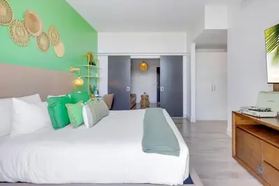 a bedroom with a large white bed with green walls at Amazing Pool - Balcony - Hollywood Beach Broad - walk in Hollywood