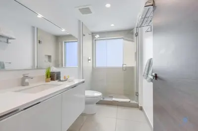 a white bathroom with a toilet and a shower at Amazing Pool - Balcony - Hollywood Beach Broad - walk in Hollywood