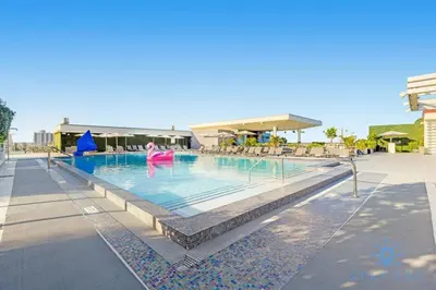 a swimming pool at a resort with people in it at Rooftop Pool & Hot Tub - Gym - Hollywood Beach in Hollywood