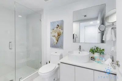 a bathroom with a toilet and a sink and a shower at Amenities BALCONY w Stunning Views-Beachfront in Hallandale Beach