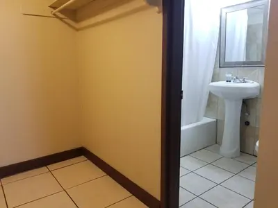 a bathroom with a sink and a toilet at Parkway Inn in Miami