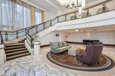 a lobby with a staircase and a couch and chairs at Studio at Sorrento Residences- FontaineBleau Miami Beach home in Miami Beach