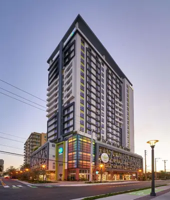 a tall building on a city street at dusk at Home2 Suites By Hilton Ft. Lauderdale Downtown, Fl in Fort Lauderdale