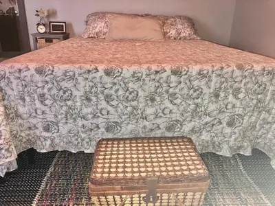 a bedroom with a bed with a comforter and a stool at Private and Secluded Studio in Little Havana - 6V in Miami