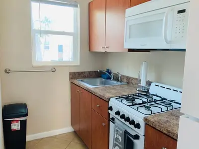 a kitchen with a stove and a sink and a microwave at Hollywood Beach Apartments - Walk to the Beach in Hollywood