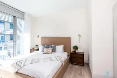 a bedroom with a large bed and a large window at Rooftop Pool - Hot Tub -Hollywood Beach Boardwalk in Hollywood