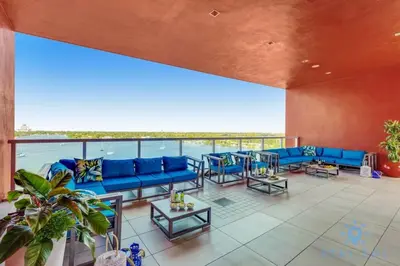 a large living room with blue couches and tables at Rooftop Pool - Hot Tub -Hollywood Beach Boardwalk in Hollywood