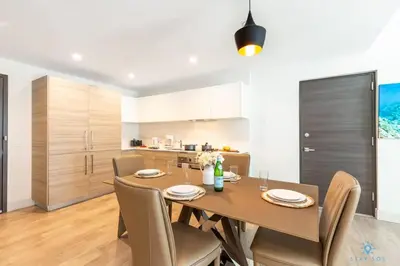 a kitchen and dining room with a table and chairs at Rooftop Pool - Hot Tub -Hollywood Beach Boardwalk in Hollywood