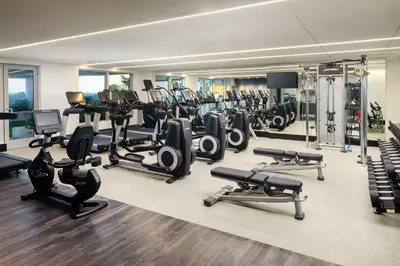 a gym with a lot of treadmills and machines at Hilton Miami Aventura in Aventura