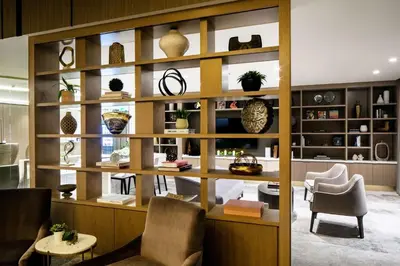 a room with shelves with vases and chairs at Hilton Miami Aventura in Aventura