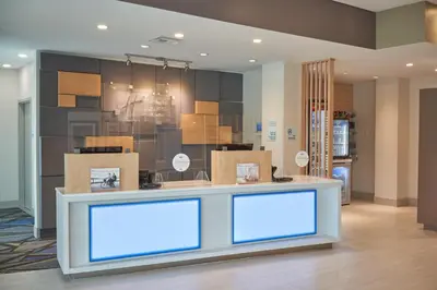 a lobby with boxes and a counter with blue lights at Holiday Inn Express Doral Miami by IHG in Doral
