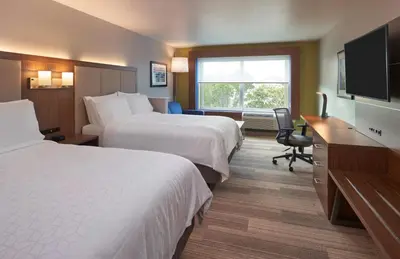a hotel room with two beds and a flat screen tv at Holiday Inn Express Doral Miami by IHG in Doral