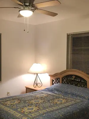 a bedroom with a bed and a ceiling fan at Beautiful Quiet Neighborhood in Miami