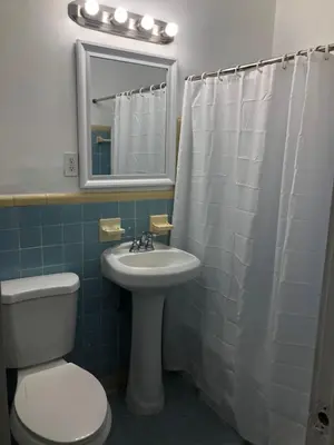 a bathroom with a sink and a toilet and a mirror at Beautiful Quiet Neighborhood in Miami