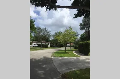 a street view of a residential street with trees at Beautiful Quiet Neighborhood in Miami