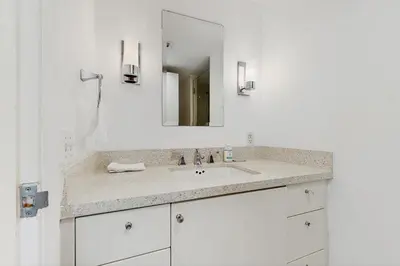 a bathroom with a sink and a mirror at The Carlyle 3G in Miami Beach