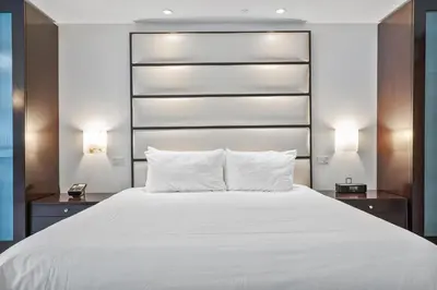 a bedroom with a large white bed with two night stands at Junior Suite at Sorrento Residences- FontaineBleau Miami Beach home in Miami Beach