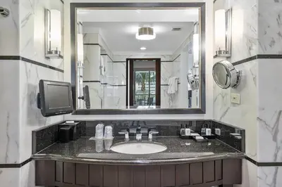 a bathroom with a sink and a large mirror at Junior Suite at Sorrento Residences- FontaineBleau Miami Beach home in Miami Beach