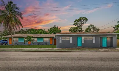 a house on a street with a palm tree at Relax and enjoy Fort Lauderdale beach! in Fort Lauderdale