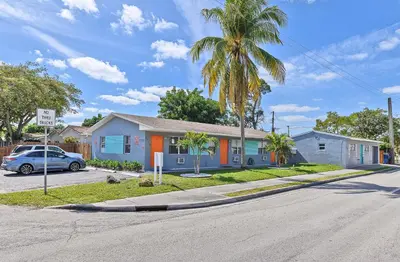 a house on a street with a palm tree at Relax and enjoy Fort Lauderdale beach! in Fort Lauderdale