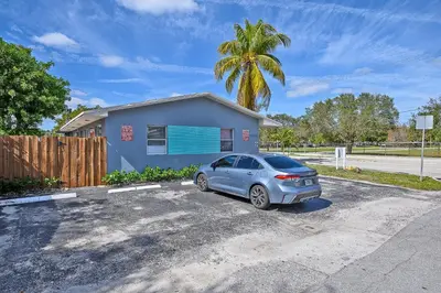 a car parked in a parking lot in front of a house at Relax and enjoy Fort Lauderdale beach! in Fort Lauderdale