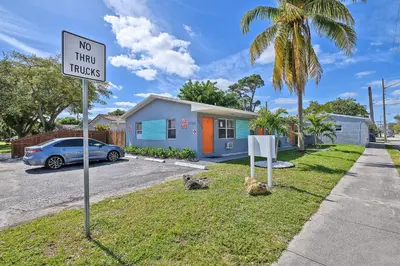 a no thru trucks sign in front of a house at Relax and enjoy Fort Lauderdale beach! in Fort Lauderdale