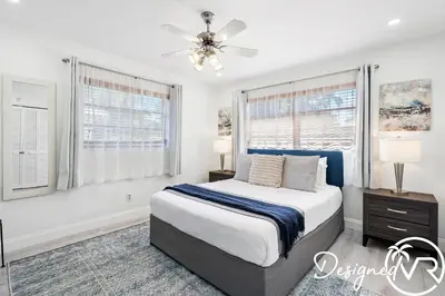 a bedroom with a bed and a ceiling fan at 4BR retreat w heated pool backyard BBQ grill in Dania Beach