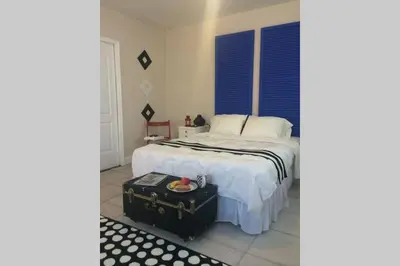 a bedroom with a bed with a trunk on the floor at Chic and Comfortable Studio Free Street Parking in Miami