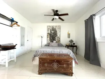 a bedroom with a bed and a ceiling fan at Private Studio blocks from Coconut Grove in Miami