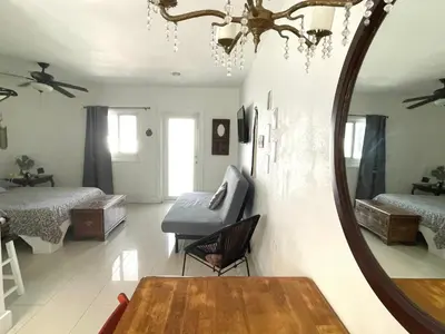 a room with two beds and a mirror on the wall at Private Studio blocks from Coconut Grove in Miami