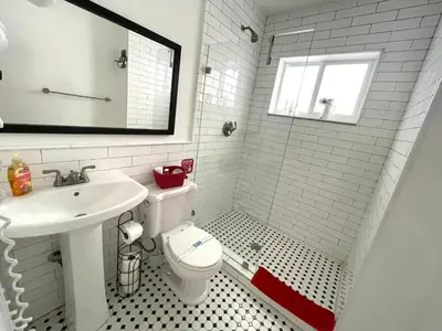 a white bathroom with a toilet and a sink at Private Studio blocks from Coconut Grove in Miami