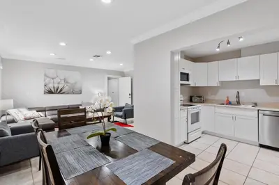 a kitchen and living room with a table and chairs at The Home in The Oaks - By Avi in Fort Lauderdale
