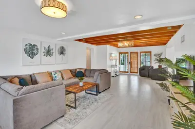 a living room with a couch and a table at Family home wpool tiki hut grill in Hollywood