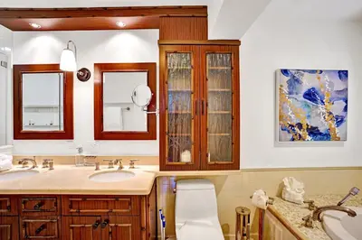 a bathroom with a sink and two mirrors and a toilet at Family home wpool tiki hut grill in Hollywood