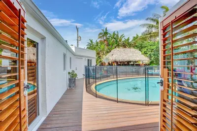 a view of the pool from the balcony of a house at Family home wpool tiki hut grill in Hollywood