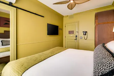 a bedroom with a bed and a flat screen tv at Esme Miami Beach in Miami Beach