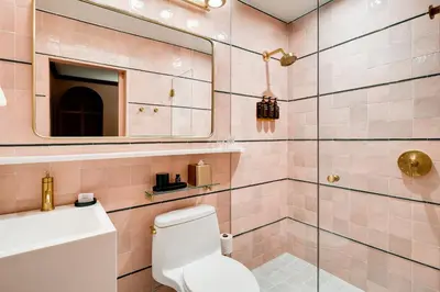a bathroom with a toilet and a sink and a mirror at Esme Miami Beach in Miami Beach