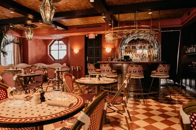 a restaurant with tables and chairs and a bar at Esme Miami Beach in Miami Beach