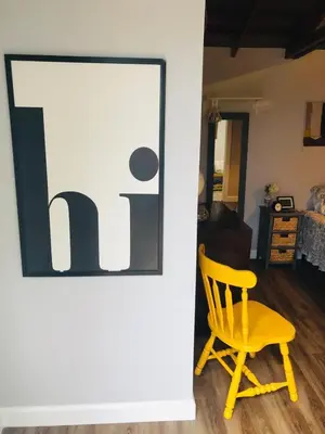 a yellow chair sitting in front of a door at Private Studio Cabin steps from Calle 8 in Miami