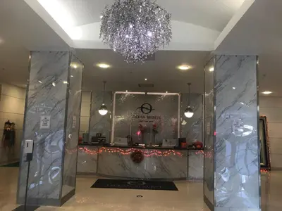 a lobby with a chandelier and a counter at The Blue Island in Miami Beach
