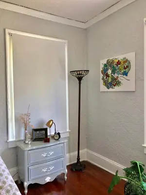 a bedroom with a dresser and a lamp and a window at Comfy and Spacious Suite with Free Parking in Miami