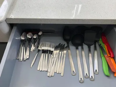 a drawer full of utensils sitting under a counter at Comfy and Spacious Suite with Free Parking in Miami