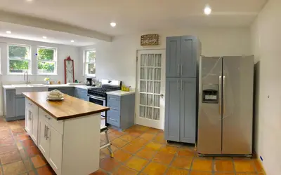a kitchen with a stainless steel refrigerator and counters at Comfy and Spacious Suite with Free Parking in Miami