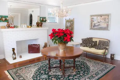 a living room with a table with red flowers on it at Cozy Aqua Private Suite with Parking in Miami