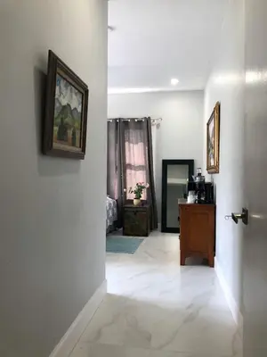 a room with a hallway with a door and a room with at Sunny and Charming Suite next to MIA in Miami