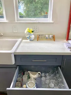 a drawer filled with dishes and a vase on a kitchen counter at Sunny and Charming Suite next to MIA in Miami