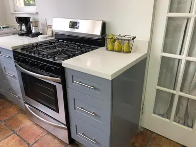 a kitchen with a stove and a counter top at Sunny and Charming Suite next to MIA in Miami