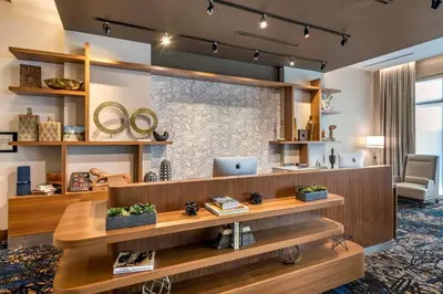 a lobby with a desk with a laptop on it at Courtyard by Marriott Fort Lauderdale Downtown in Fort Lauderdale