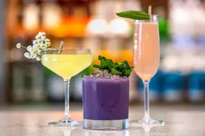 three cocktails sitting on top of a table at Courtyard by Marriott Fort Lauderdale Downtown in Fort Lauderdale