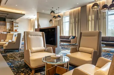 a lobby with chairs and a flat screen tv at Courtyard by Marriott Fort Lauderdale Downtown in Fort Lauderdale